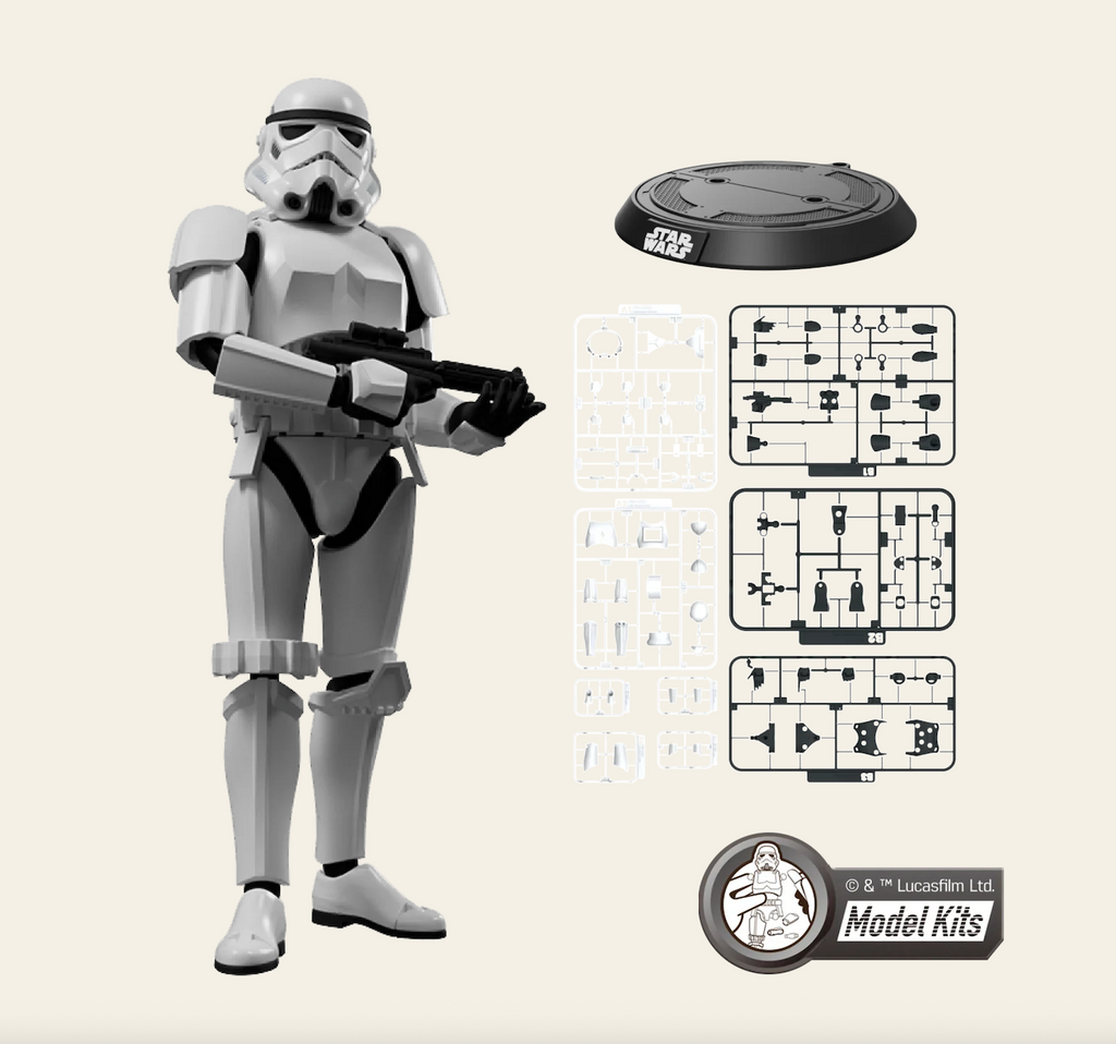 Star Wars stormtrooper model kit with the stormtrooper standing beside the frames that hold the pieces and the display stand. 