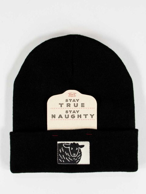 Black beanie with a black sheep on a white tag embroidered on front. Also has the removeable cardboard packaging that reads Stay True Stay Naughty on it. 