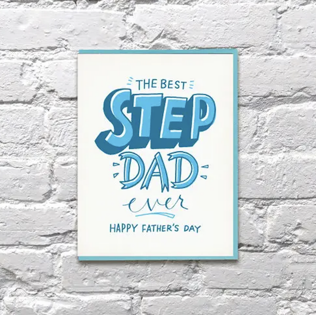A white greeting card with dark and light blue lettering that reads "The  Best Step Dad, Ever. Happy Father's Day"