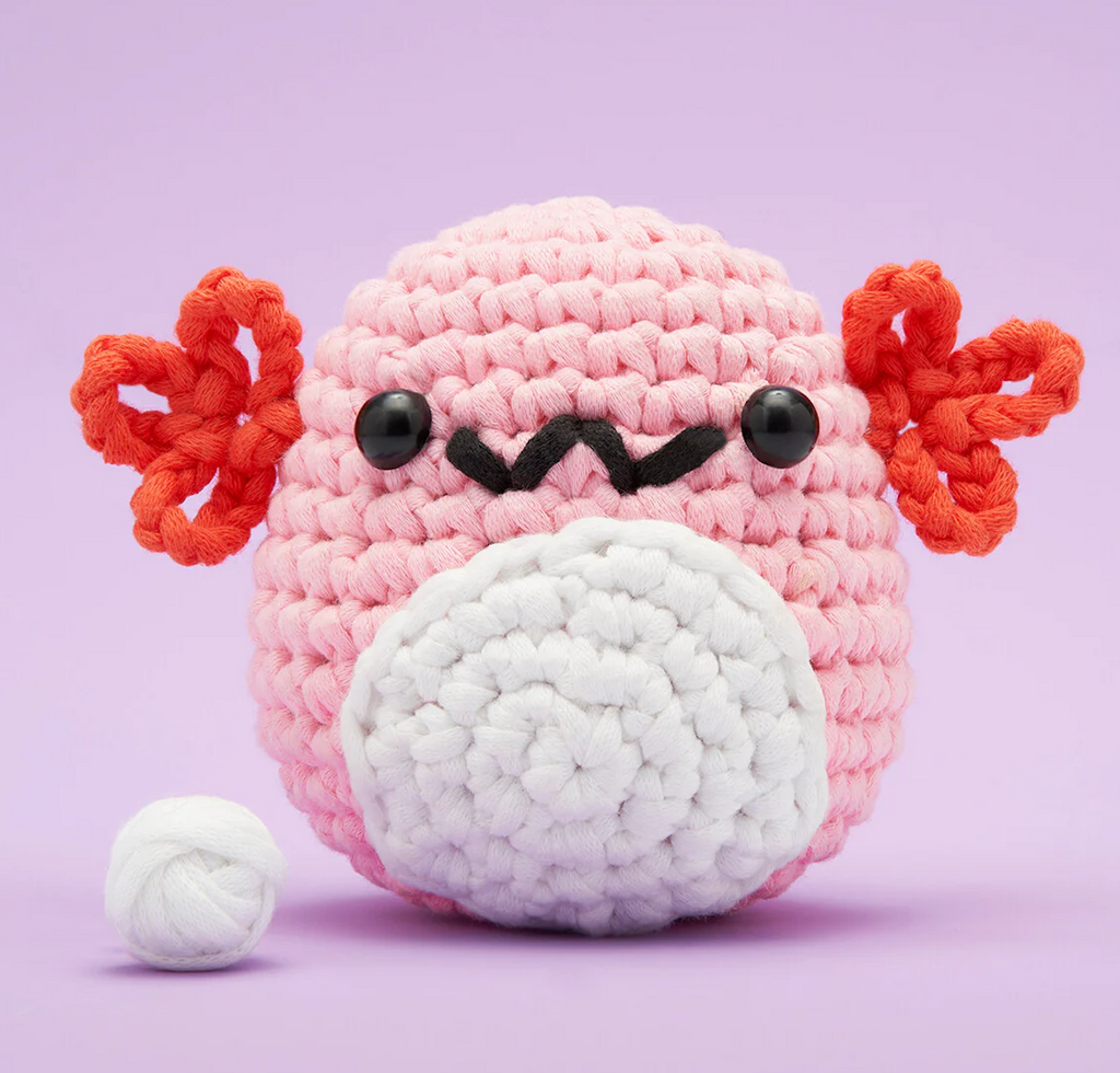 A Strawberry Axolotl crocheted friend made using the Woobles Strawberry the Axolotl Crochet Kit. 