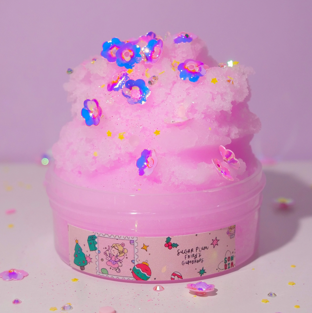 AN overflowing tub of Sugar Plum Fairy's Gumdrops slime with flower shaped add ins. (Not food)