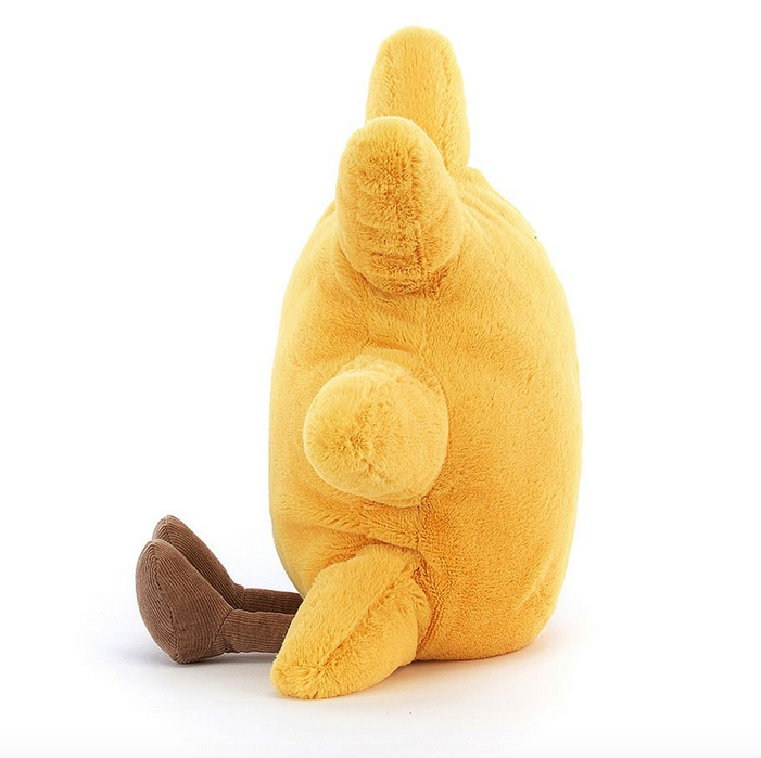 Side view of  the Amuseable Sun plush, yellow plush covers it's body an drays. It's brown feet are out in front 