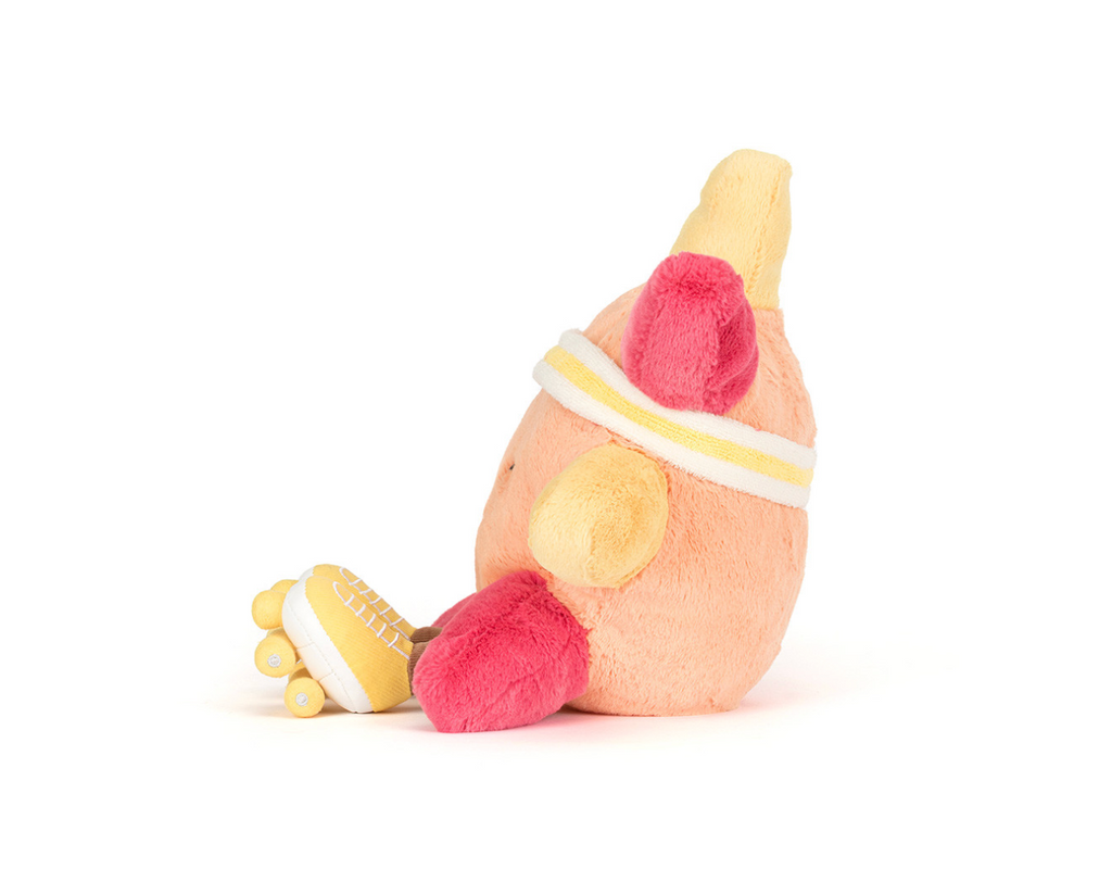 Side view of an orange and yellow plush sun wearing a headband and roller skates sitting on a white background.