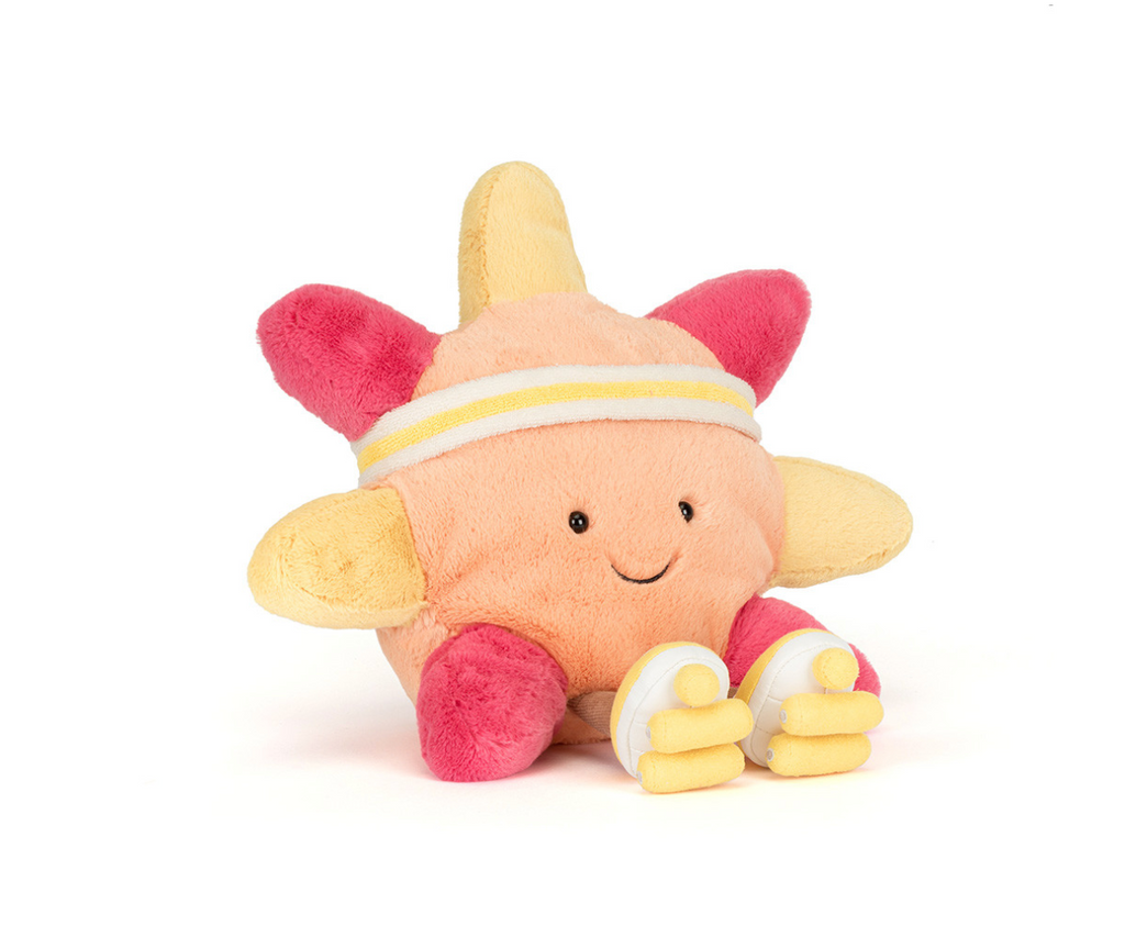 Orange and yellow plush sun wearing a headband and roller skates sitting on a white background.