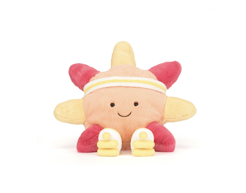 Orange and yellow plush sun wearing a headband and roller skates sitting on a white background.