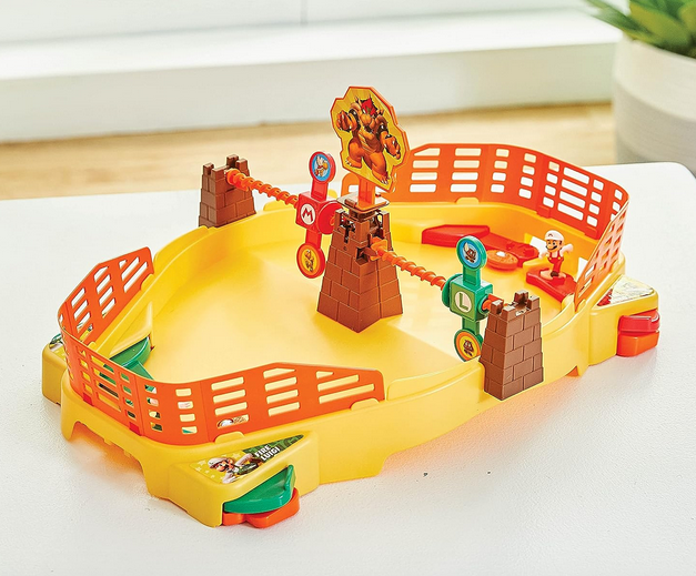The Super Mario Fire Mario Stadium out of the box. The stadium is yellow with orange barriers and red and green targets. Flippers on the side alolow you to move your figures to launch the fire ball disk. 