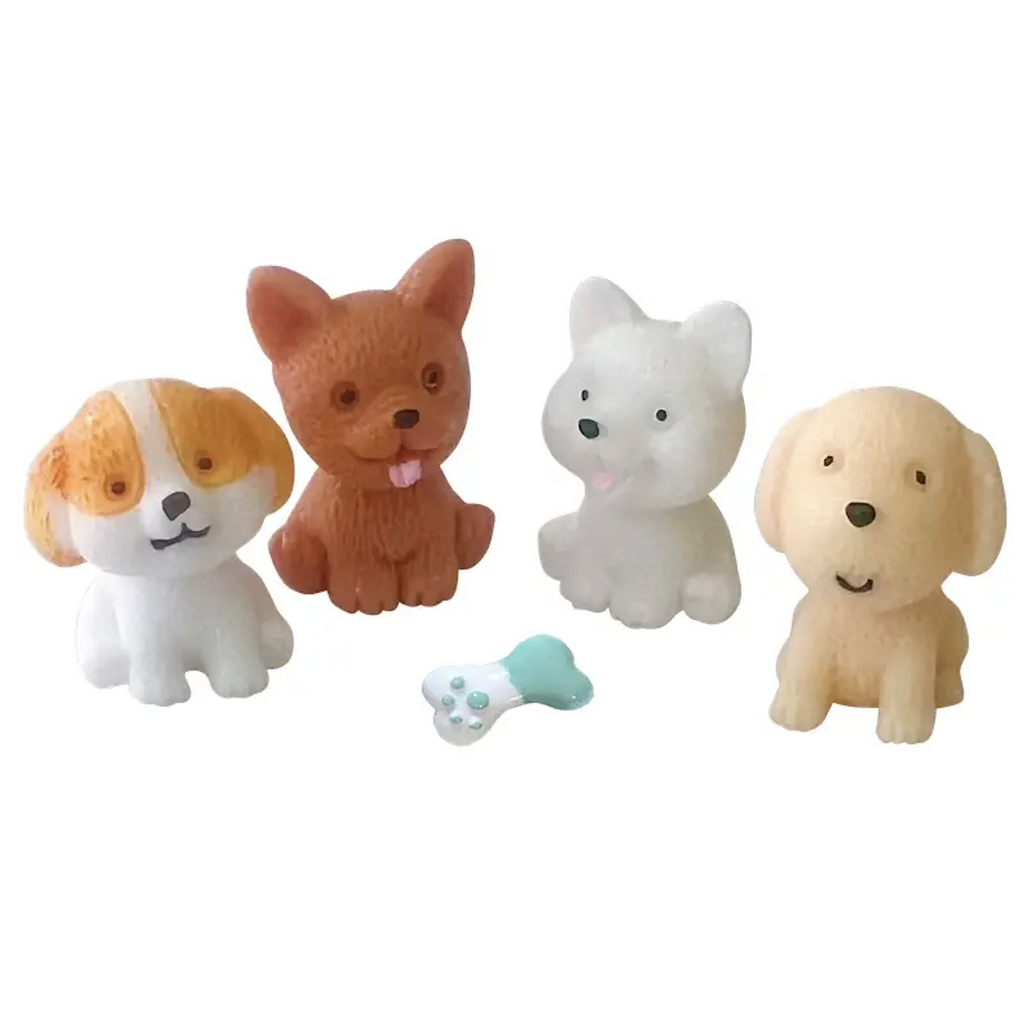 Set of four squishy puppies with a squishy bone. 