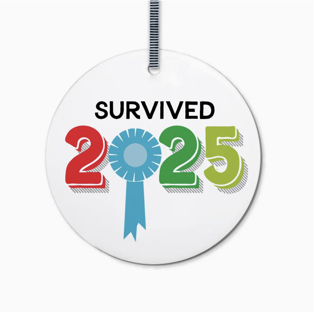 Round ceramic ornament with text on a white background.