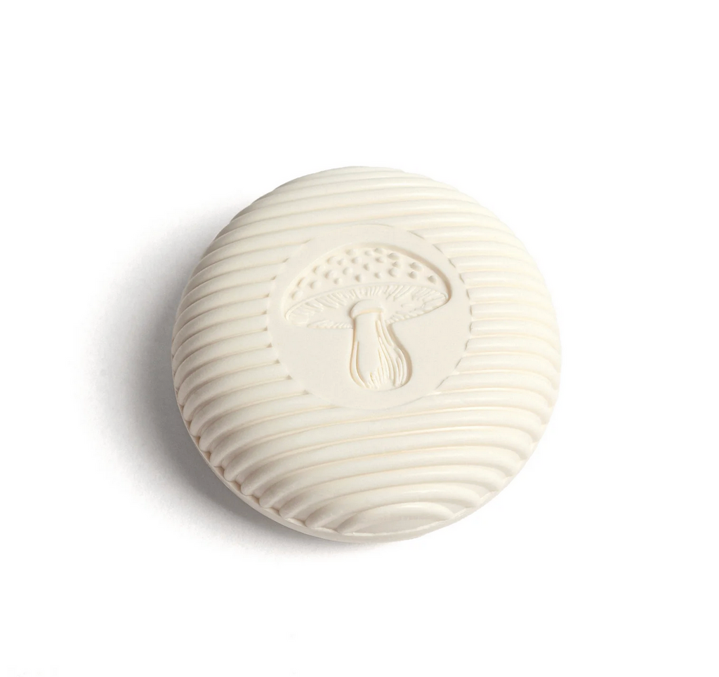 White soap embossed with a mushroom on a white background.