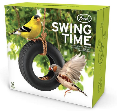 Box with colorful picture of the "Swing Time" bird feeder which is a ceramic tire suspended from a brown rope hanging in a tree. There are to birds feeding on the bird seed inside the tire. 