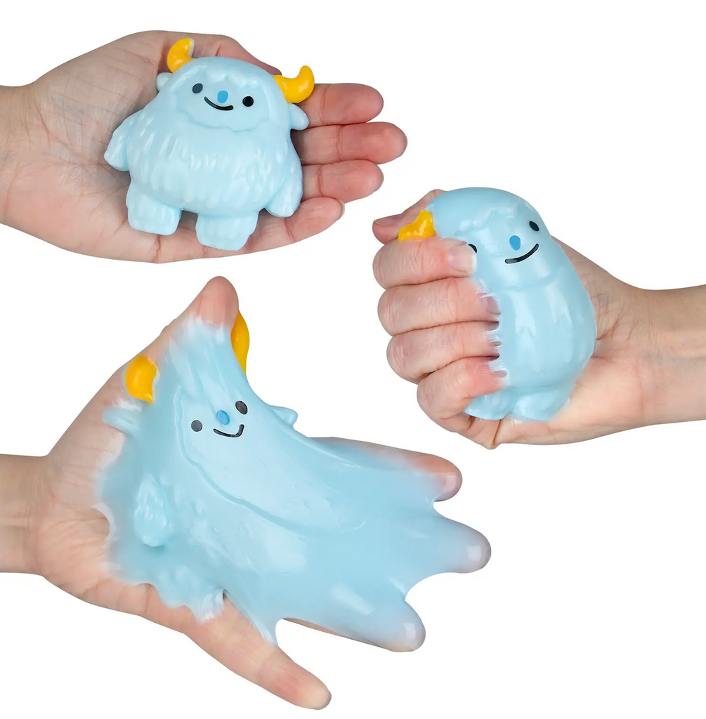 Hands holding and squeezing the yeti Taba-Licious Polar pal. 