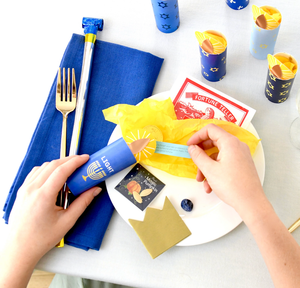 A Hanukkah table set with the candle shaped Tabletop Surprizes with Hanukkah themed decorations. 