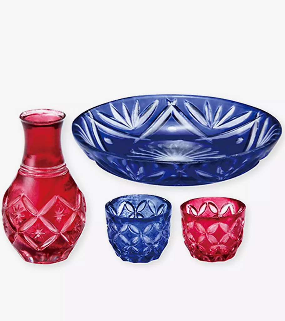 Miniature crystal dished of a red carafe, blue bowl and matching glasses. 