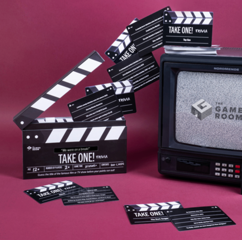 Take One! Trivia game box opened to show question cards from the game that also look like a slate used in filming. 