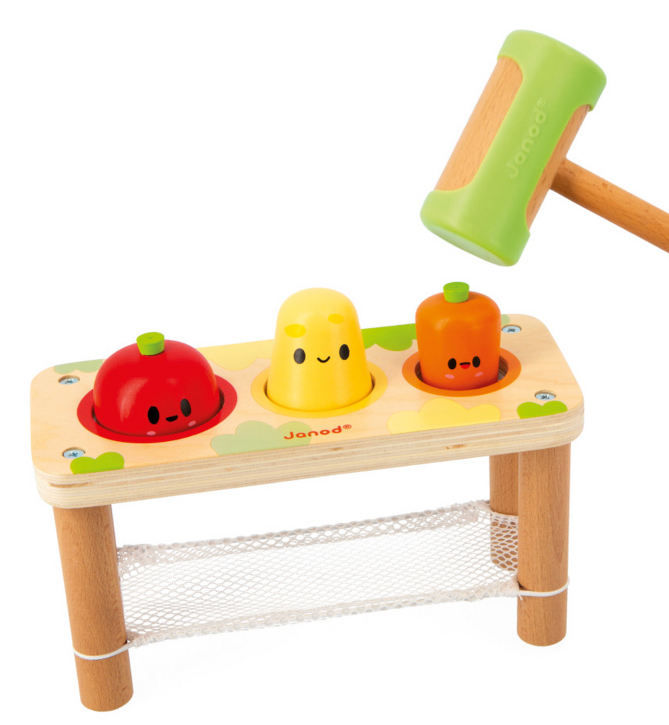 Tap Tap Vegetables wooden pounding bench with color veggies a red tomato yellow potato and orange carrot waiting to be tapped through the bench into the net below. 