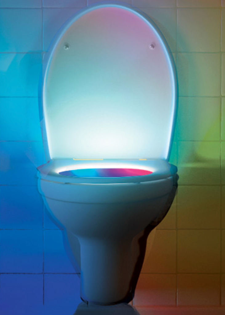 A real toilet with the seat up and multicolored light shining out. 