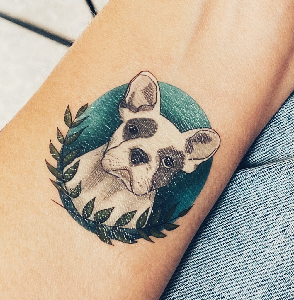 Temporary tattoo of a frenchie applied to a forearm. 