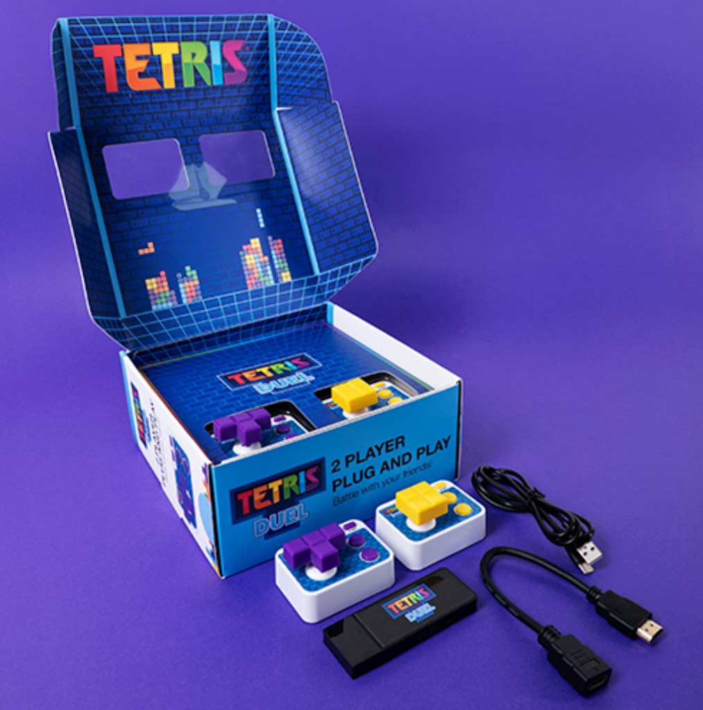Tetris Duel 2 Player Plug and Play box opened up and showing the HDMI dongle and leads to plug the Tetris Duel into your TV, as well as the two Tetrimino wireless controllers.