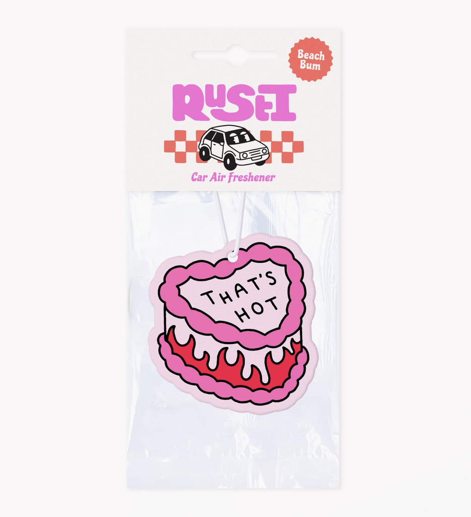 Car Air Freshener shaped like a heart shaped cake that reads "That's Hot" packaged in clear plastic. 