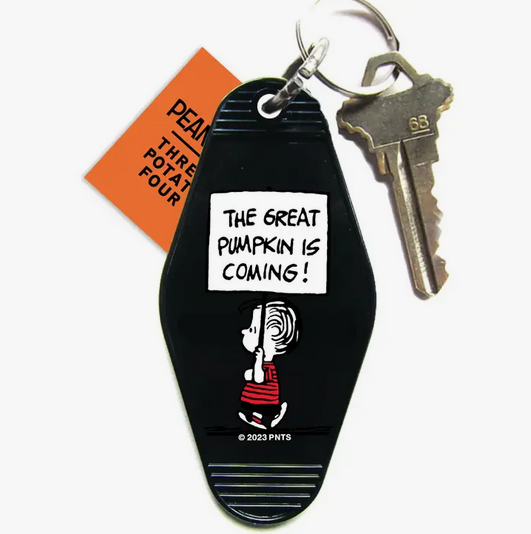 Black plastic key tag with Linus carrying a sign that reads "The Great Pumpkin is Coming!"