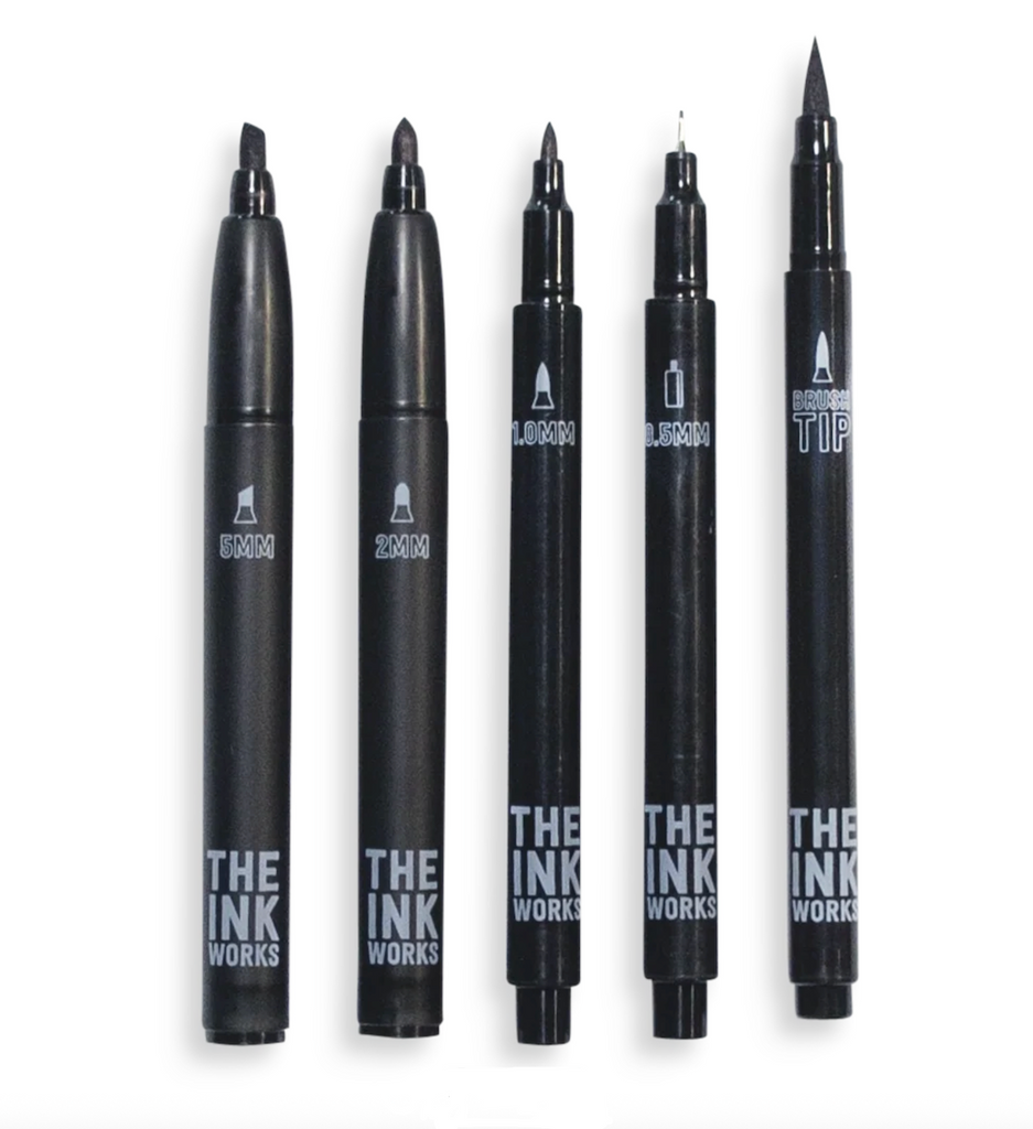Set of 5 black markers with different sizes and styles of tips. The barrels are all black with white writing. 