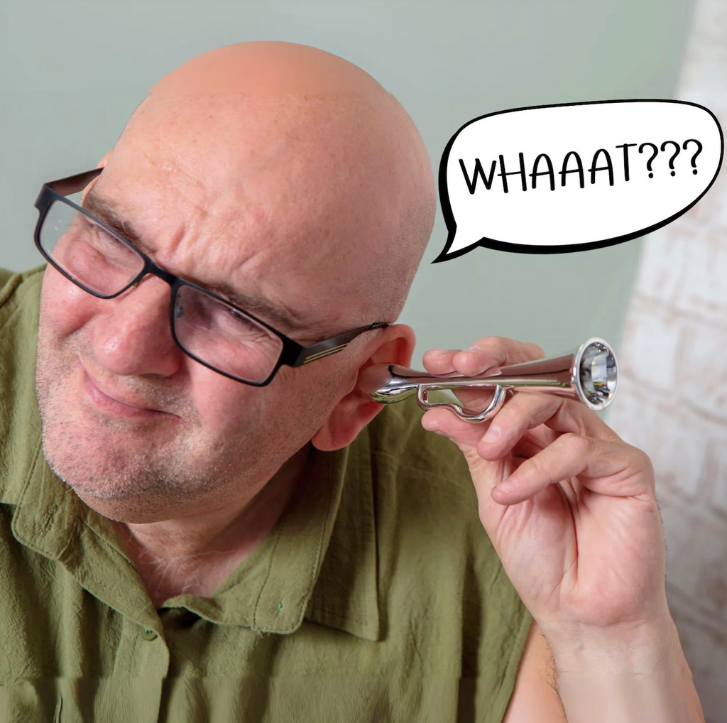 Man with glasses holding a trumpet to his ear, with a speech bubble saying 'WHAAAT???'