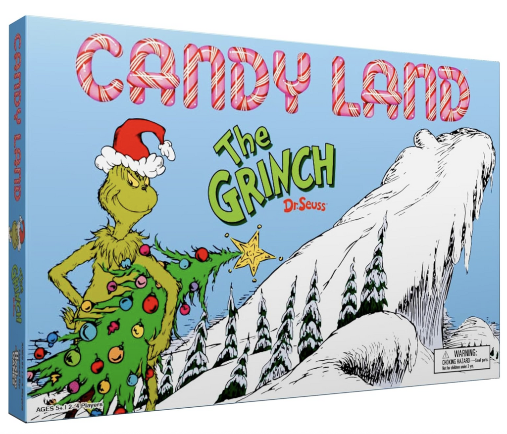 Cover of The Grinch Candy Land board game with an illustration of a snow covered mountain slope with the Grinch holding a decorated Christmas tree, wearing a Santa hat and an look as if he's up to no good. 
