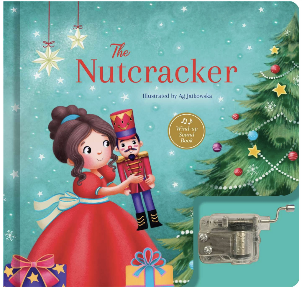 Cover of The Nutcracker with an illustration of Clara dancing with the Nutcracker and a hand wound music box attached to the cover. 