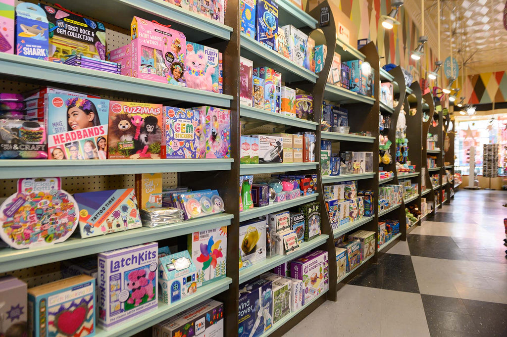 Image of shelves filled with toys in World of Mirth Toy Store.