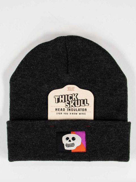 Black beanie with a white skull on a black, purple, and orange embroidered tag. Also has removeable cardboard tag that reads, Thick Skull Head Insulator. 