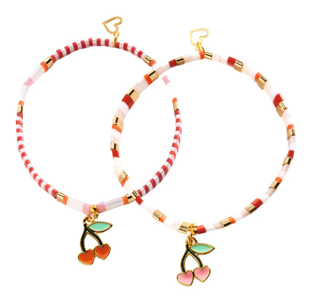 Two bracelets with cherry charms and red and white brads made usinmg the bead kit. 