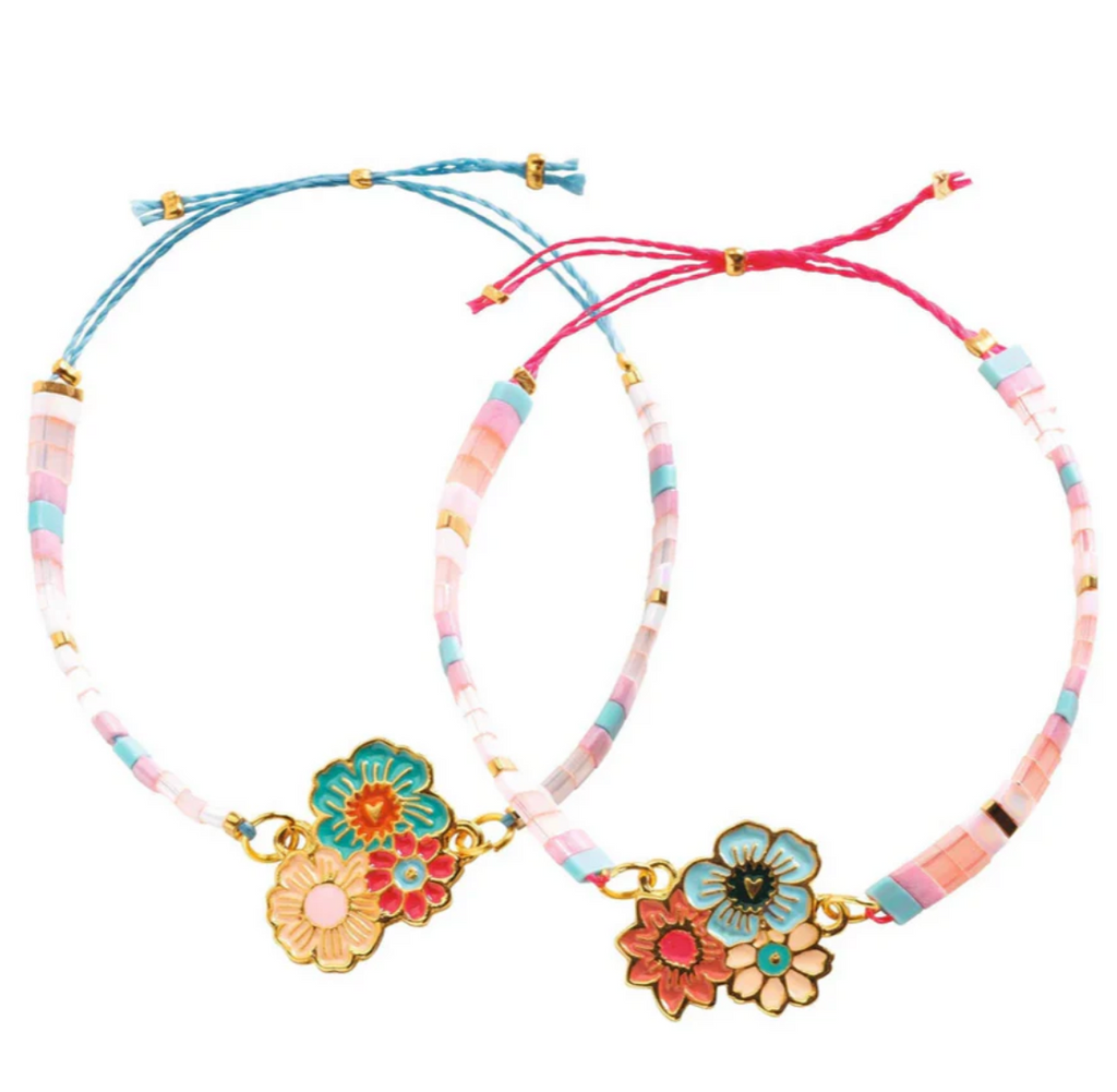 Two bracelets with flower charms and pastel colored beads. 