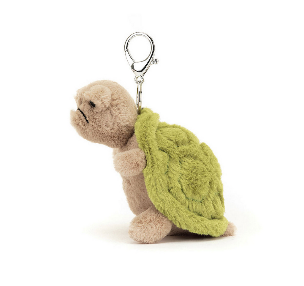 Side view of Timmy Turtle Jellycat bag charm. 