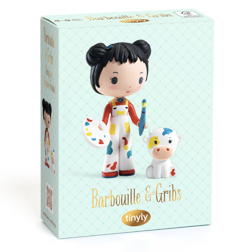 Blue patterned box with a picture of Barbouille holding her art pallete and paint brush with Gribs her faithful companion pictured on the front. 