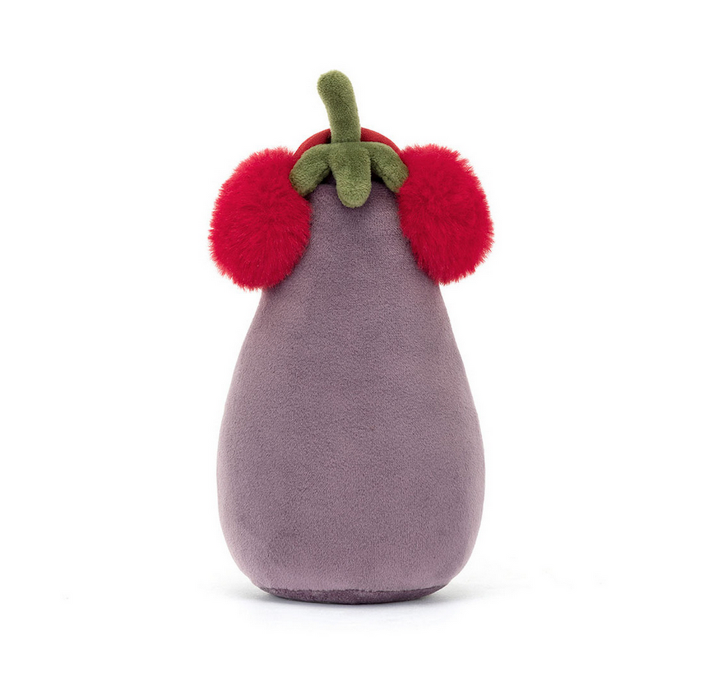 Velvety purple eggplant stuffed animal from Jellycat wearing red ear muffs viewed from the back. 