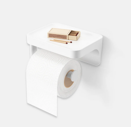 The Toilet Paper Holder and Shelf attached to a wall with a roll of toilet paer and a matchbook on the shelf.