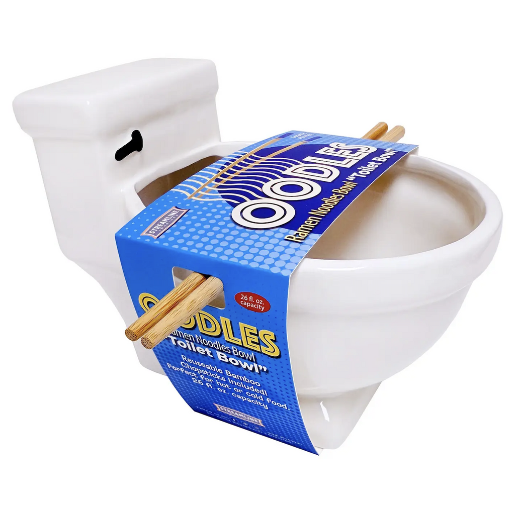 The Toilet Ramen Bowl, a white ceramic toilet shaped bowl with bamboo chopsticks resting across the top of the bowl with a blue banded label around the bowl. 