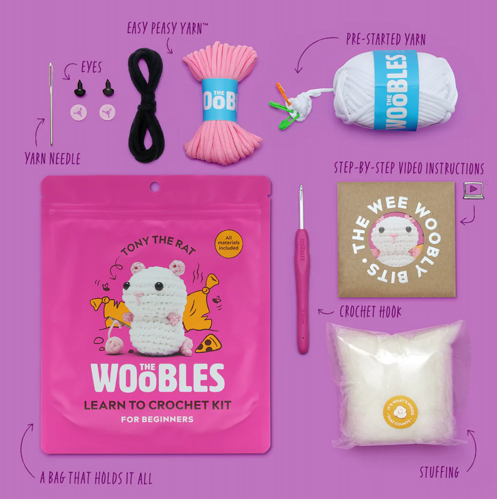 Woobles learn to crochet kit with three colors of  yarn, crochet hook, yarn needle, plastic eyes, stuffing and instructions along with the bright pink bag with Tony the Rat pictured on the front. 