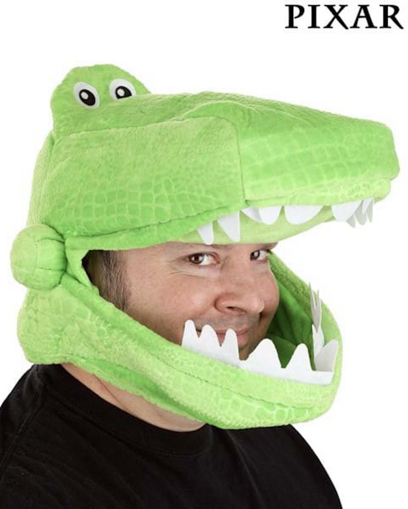 A funny guy wearing the Toy Story Rex Jawsome hat, it's green plush dinosaur hat with the view port at Rex's mouth in between his sharp white teeth. 