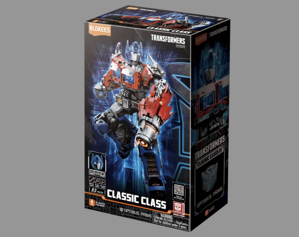 Transformers One Classics Class Optimus Prime model kit, packaged in a black box featuring a picture of the completely built model of Optimus Prime flying through the air. 