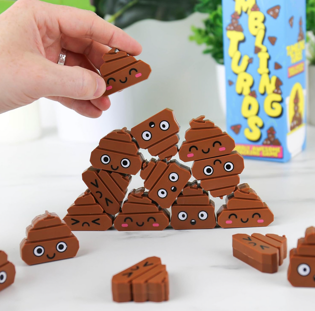 Some of the poop emoji game pieces being stacked. 