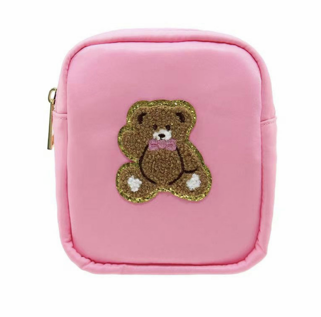 Pink nylon bag features a cute brown bear embroidered in fluffy chenille and outlined in gold. 