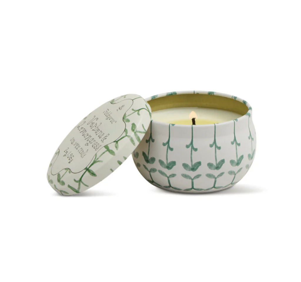 Verbena and Lemongrass scented candle in a green and white decorative tin with a leaf pattern. 