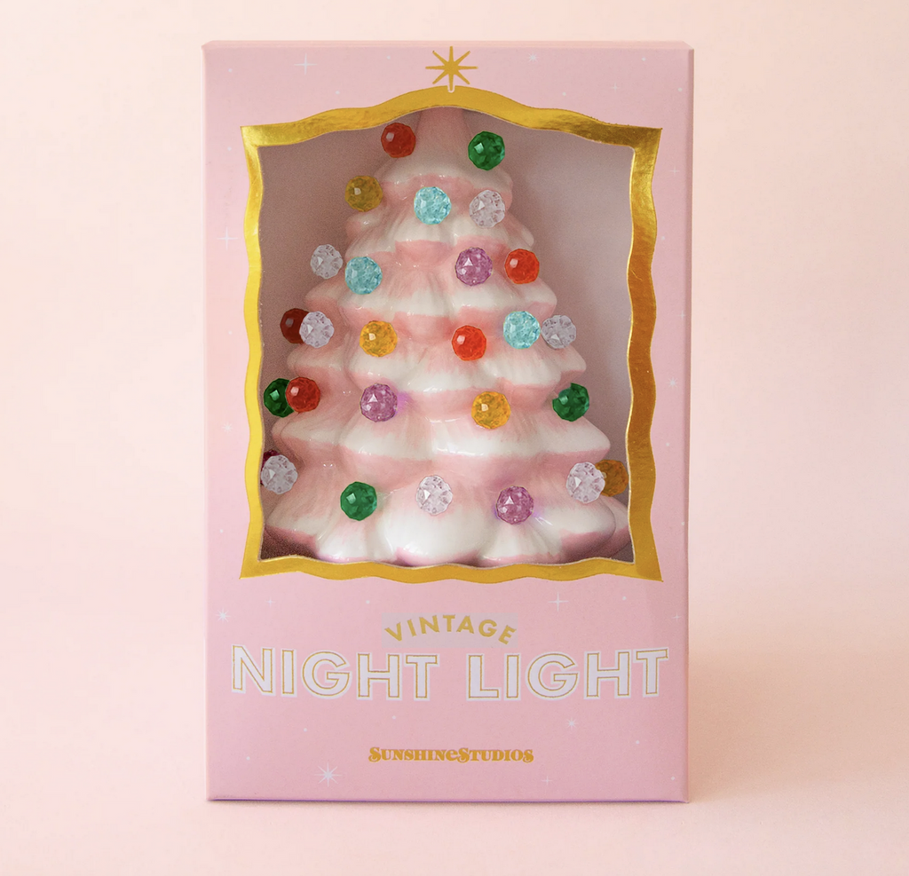 Pink ceramic Christmas tree night light with brightly colored beads at the end of the branches of the tree packaged in a pink box with an open "window" at the front of the box. 