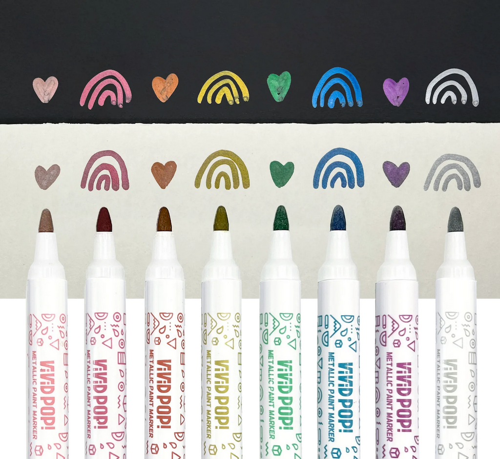 Each of the 8 Metallic Paint Markers used to draw on white and black paper. 