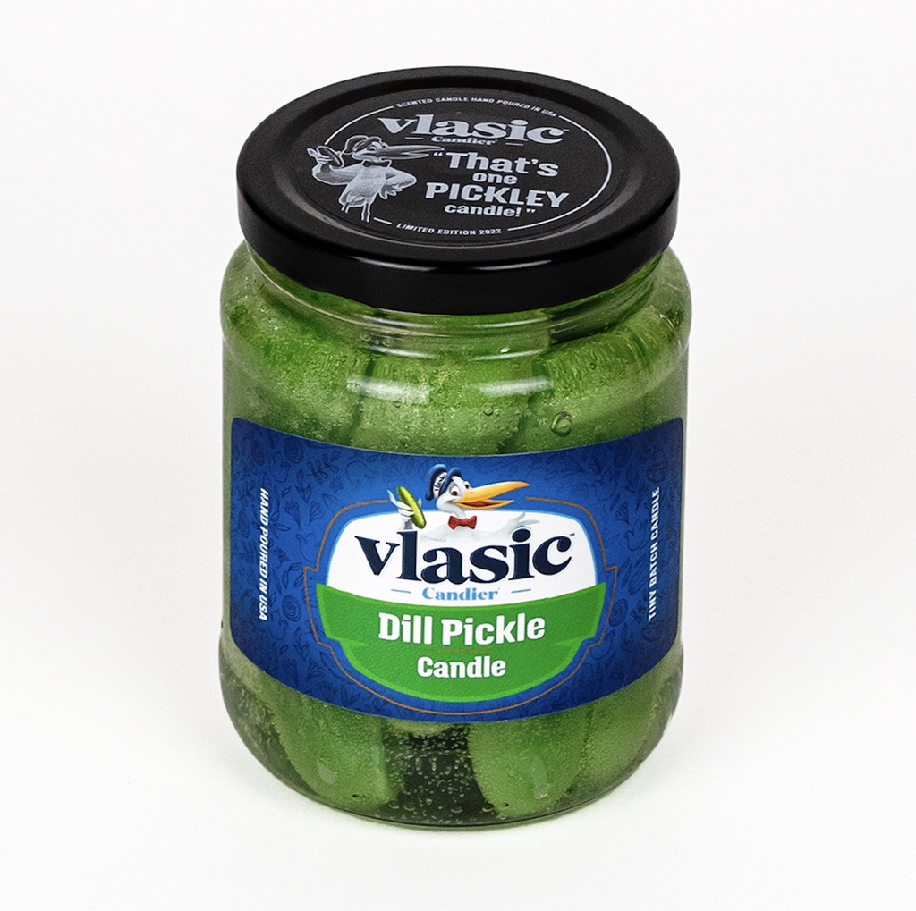 Clear glass jar of Vlasic Dill Pickle Candle, with wax pickles inside clear gel wax. The top of the jar is black with white lettering that reads Vlasic That's on pickley candle!