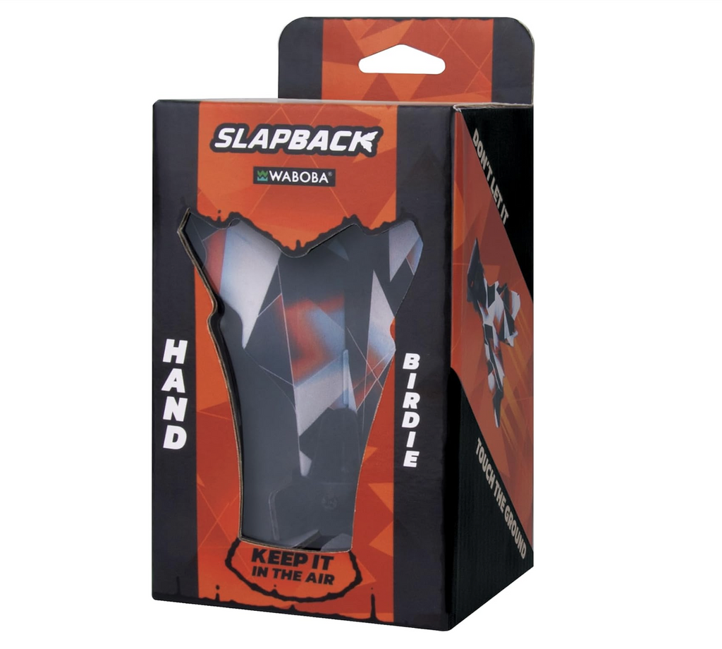 The Waboba Slapback packaged in an orange and black box with pictures of the featherless birdie on the sides. 
