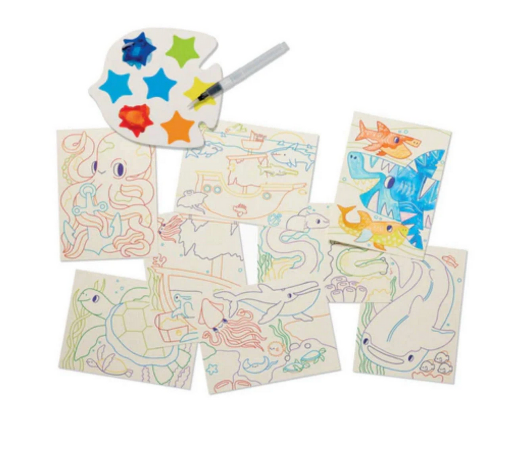 The Watercolor Magic paint palette with several of the coloring sheets from the set.