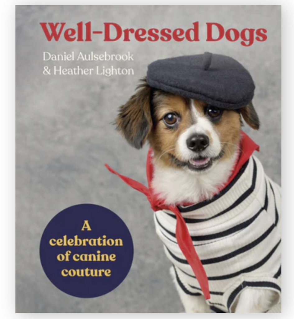 Cover of "Well Dressed Dogs" with a sharply dressed pup wearing a sweater, kerchief and cap. 