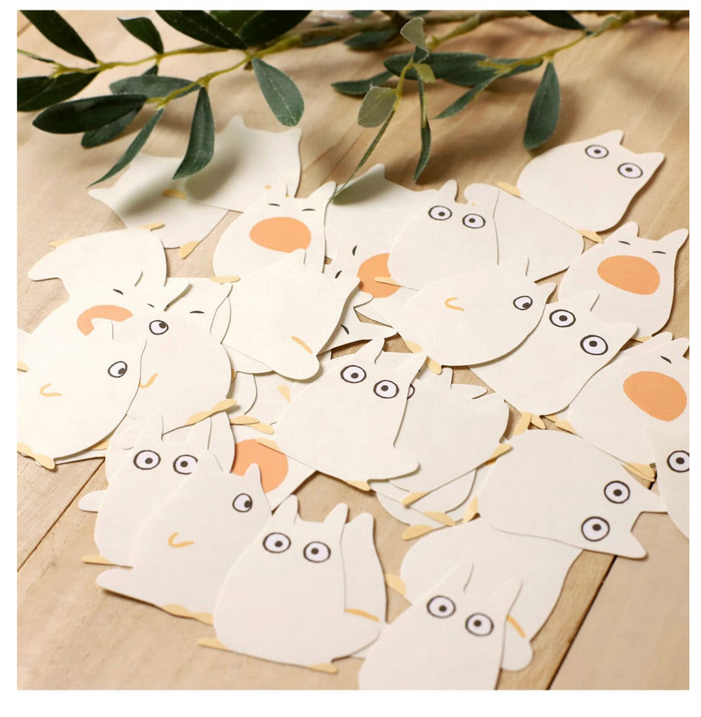 White totoro shaped sticky notes on a table.